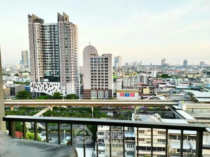 Stunning cityscape view from a high-rise balcony overlooking urban skyline and modern architecture.