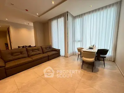 Spacious modern living room with elegant dining area and floor-to-ceiling windows