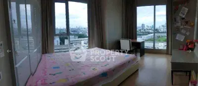 Spacious bedroom with panoramic city views and ample natural light