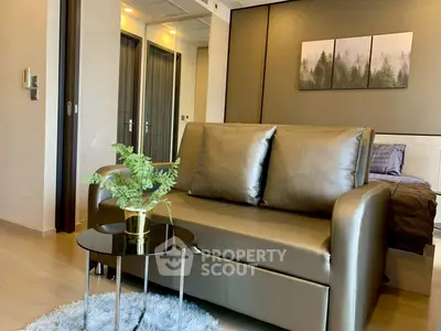 Modern living room with sleek sofa and stylish decor in contemporary apartment.