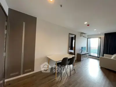 Modern living room with sleek furniture and balcony view