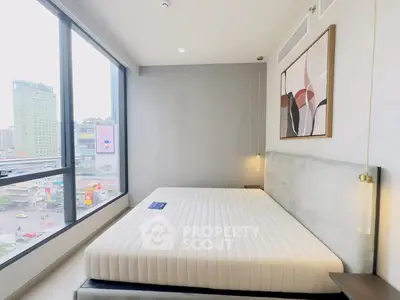 Modern bedroom with large window and stylish decor in urban apartment