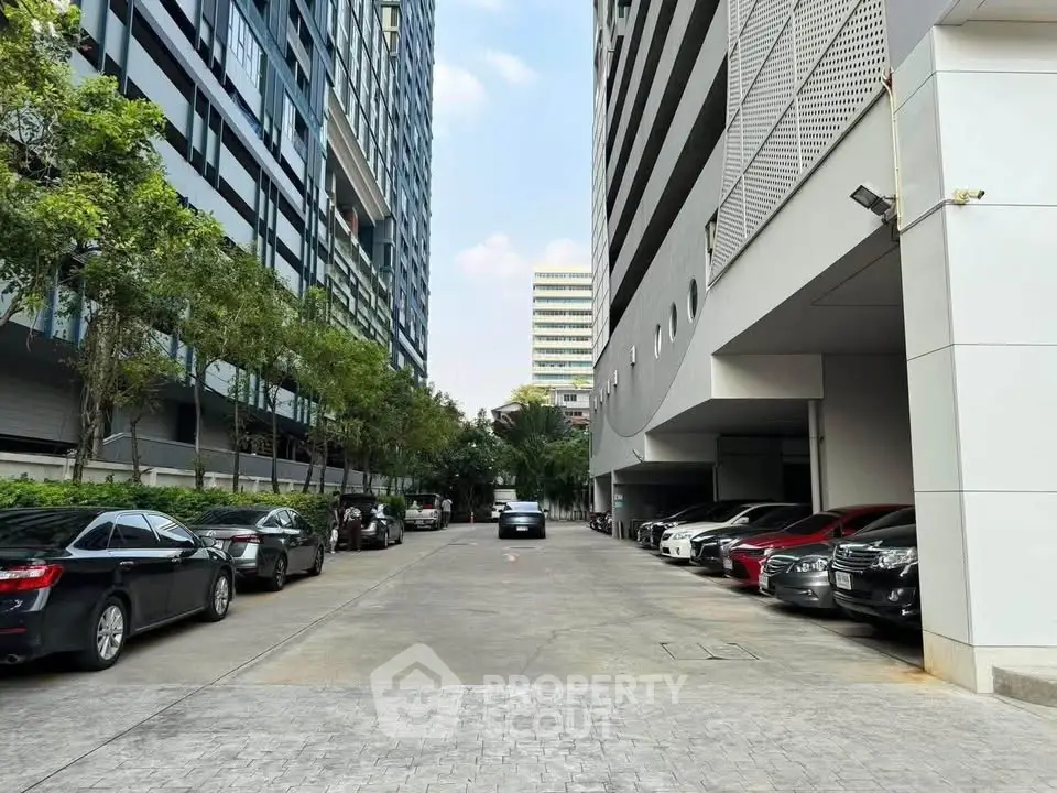 Modern urban parking area with sleek building architecture and ample parking space.