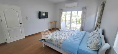 Bright bedroom with balcony access and modern decor