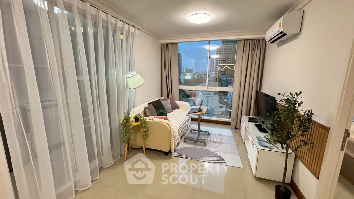 Cozy living room with modern decor and city view, perfect for relaxation.