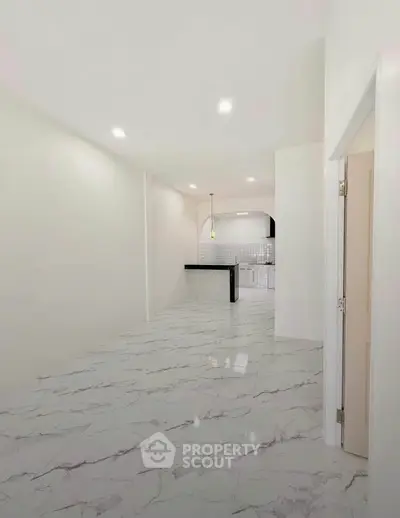 Spacious modern kitchen with marble flooring and sleek design