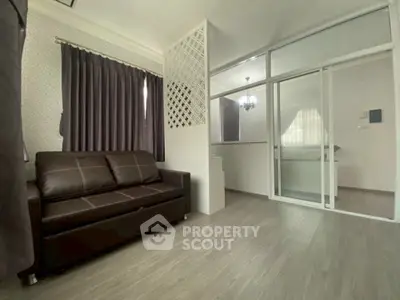 Modern living room with elegant dark curtains and sleek leather sofa