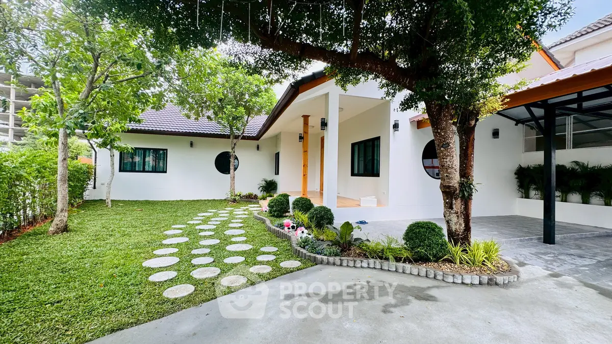 Charming single-story home with lush garden and modern exterior design, perfect for family living.