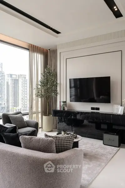 Luxurious modern living room with city view, elegant furniture, and large TV setup.