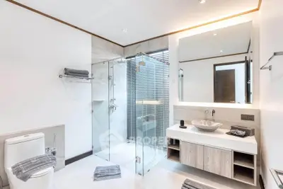 Luxurious modern bathroom with glass shower and elegant fixtures