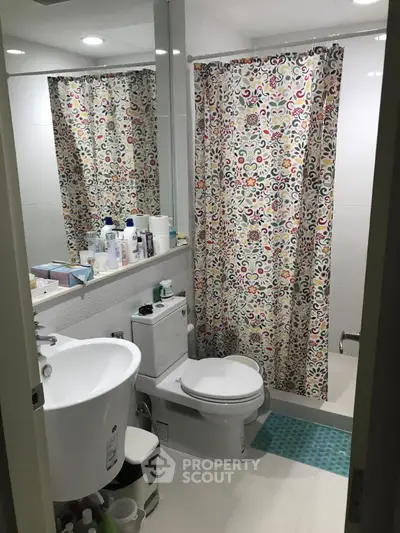 Cozy bathroom with colorful shower curtain and modern fixtures