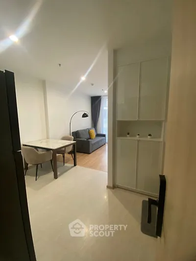 Modern living room with dining area and stylish furniture in a cozy apartment.
