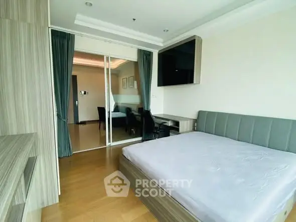 Modern bedroom with sleek design and large window, featuring a comfortable bed and stylish decor.