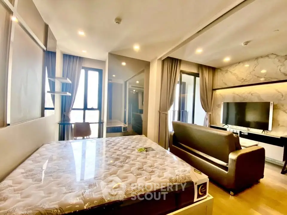 Modern studio apartment with stylish decor and large windows