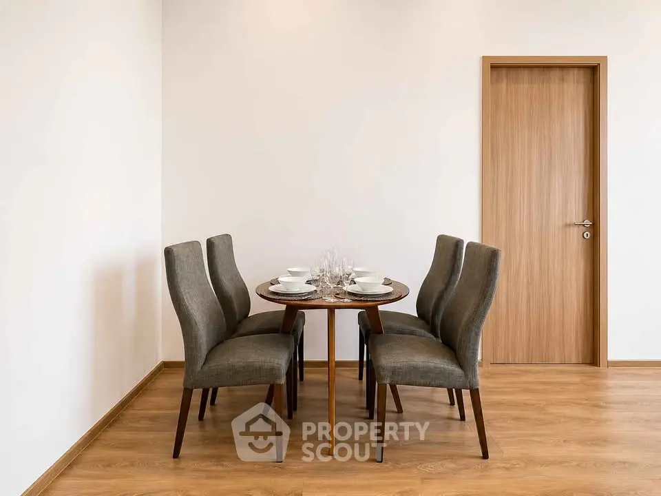 Elegant dining area with modern table and chairs on wooden flooring, perfect for intimate gatherings.