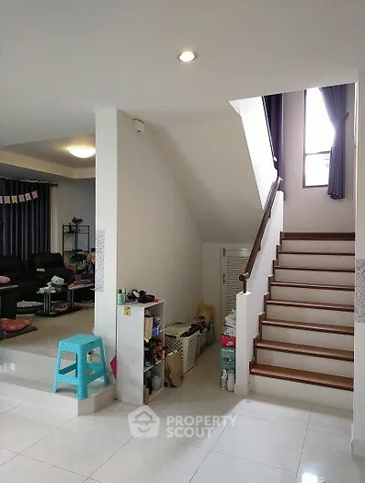 Spacious modern living area with staircase and stylish decor