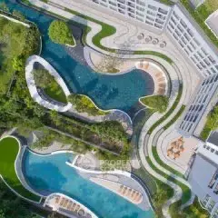 Stunning aerial view of luxurious pool and landscaped garden in modern property.