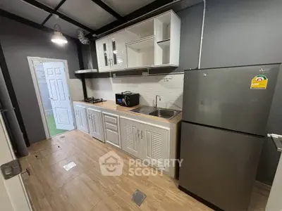 Modern kitchen with sleek cabinetry and stainless steel appliances in a compact layout.