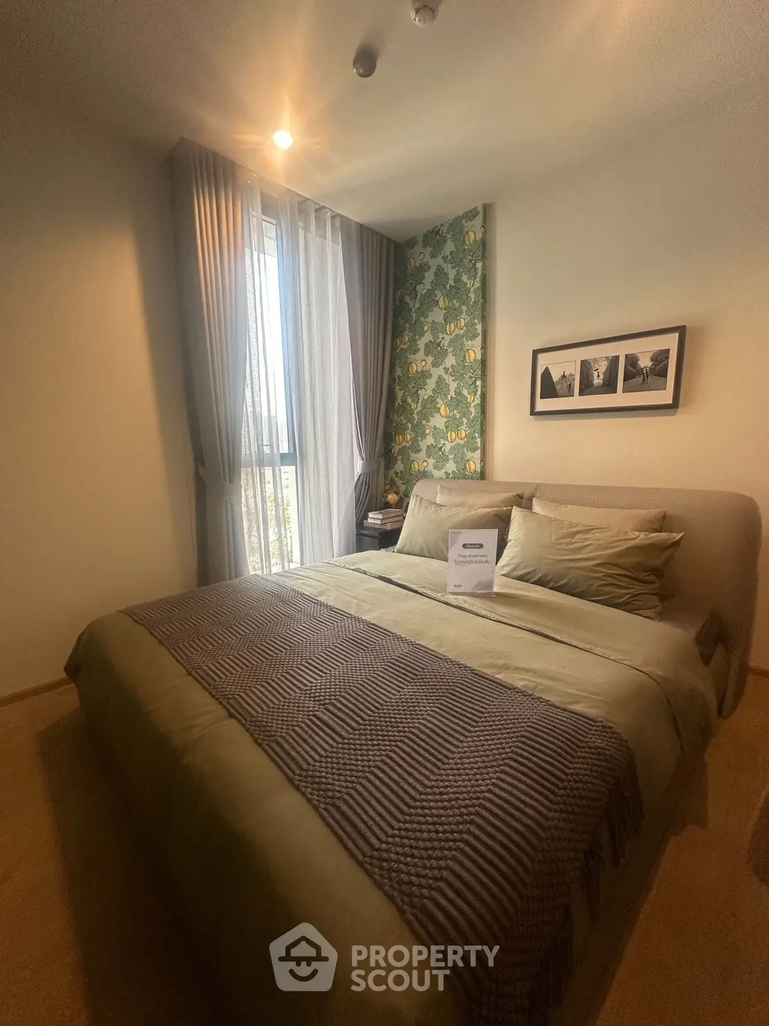 Cozy bedroom with stylish decor and natural light, perfect for relaxation and comfort.