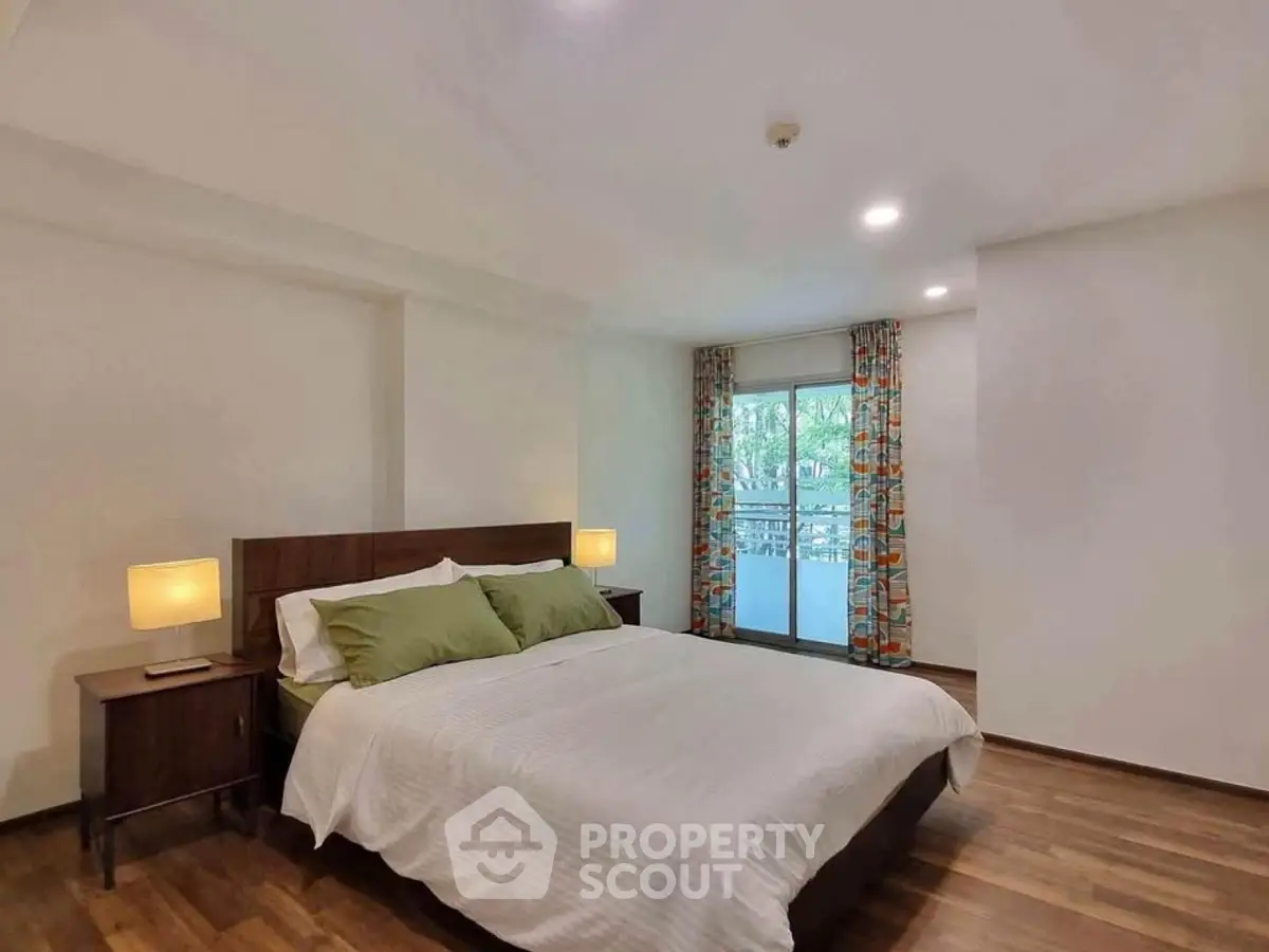Spacious bedroom with balcony access and modern decor