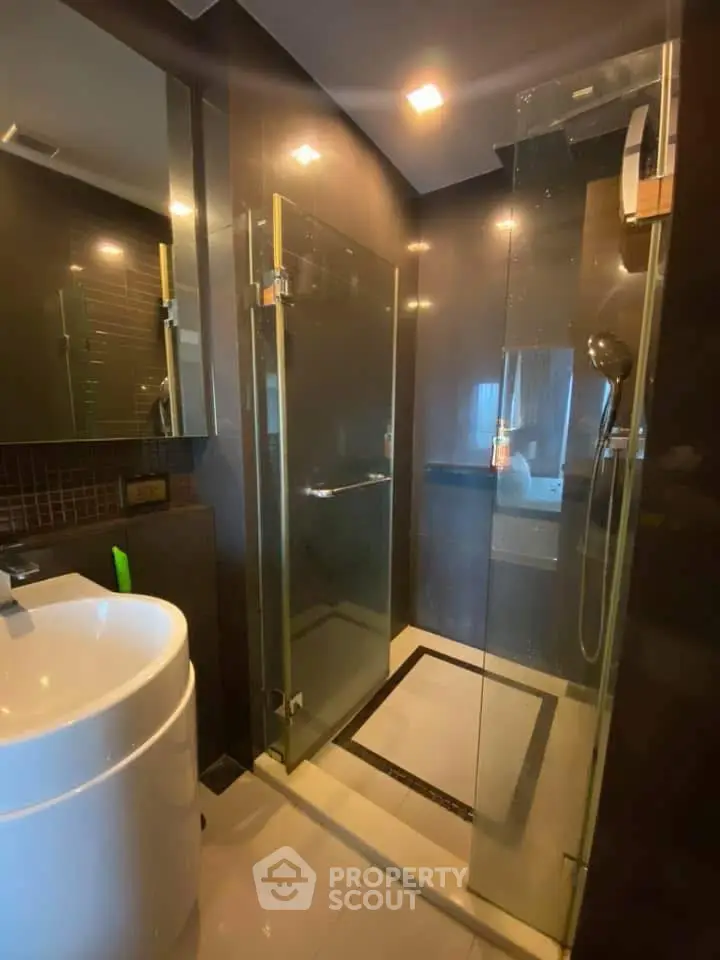 Modern bathroom with glass shower and sleek fixtures