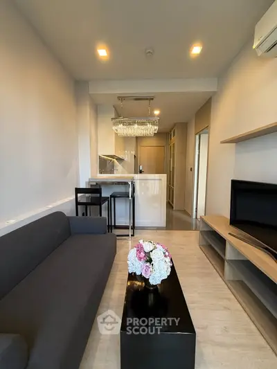 Modern living room with sleek furniture and elegant lighting in a stylish apartment.