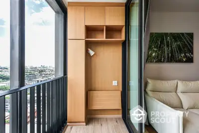 Modern apartment balcony with wooden storage and city view