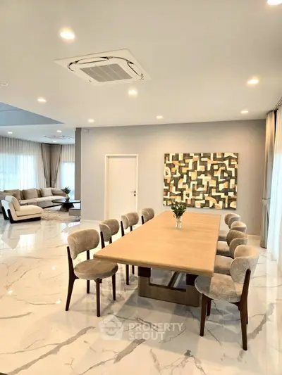 Spacious modern living and dining area with elegant decor and ample natural light.