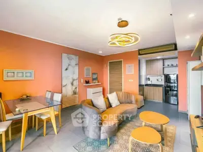 Stylish modern living room with open kitchen and unique lighting fixtures.