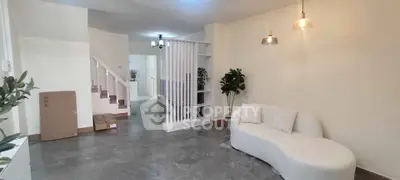 Spacious living room with modern decor and unique sofa, perfect for relaxation and entertaining.