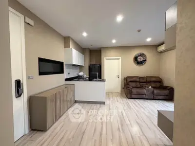 Modern living room with open kitchen layout and stylish decor
