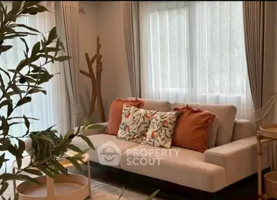 Charming living room with cozy sofa and stylish decor, perfect for relaxation and entertaining.