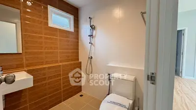 Modern bathroom with sleek shower and stylish brown tiles