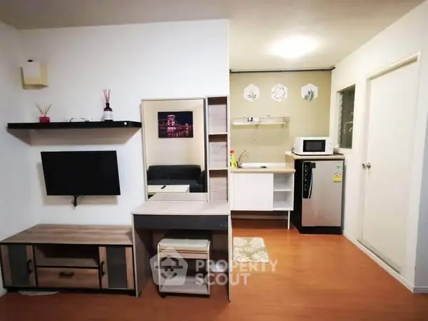 Modern studio apartment with compact kitchen and stylish decor