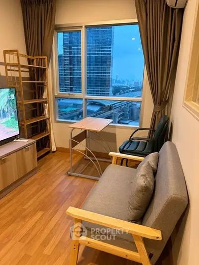 Cozy living room with city view, modern furniture, and wooden flooring
