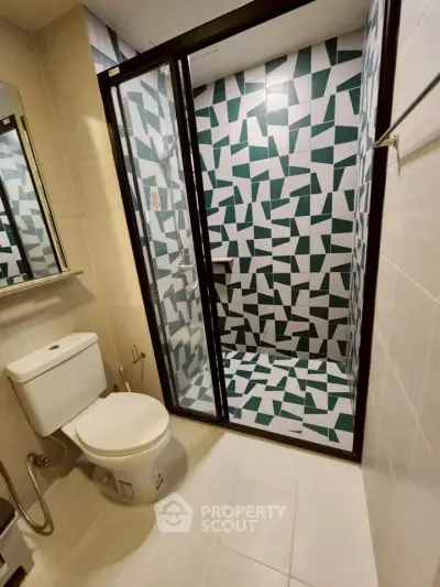 Modern bathroom with geometric tile shower and sleek fixtures
