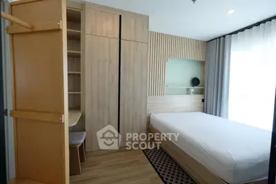 Modern bedroom with built-in wardrobe and natural light