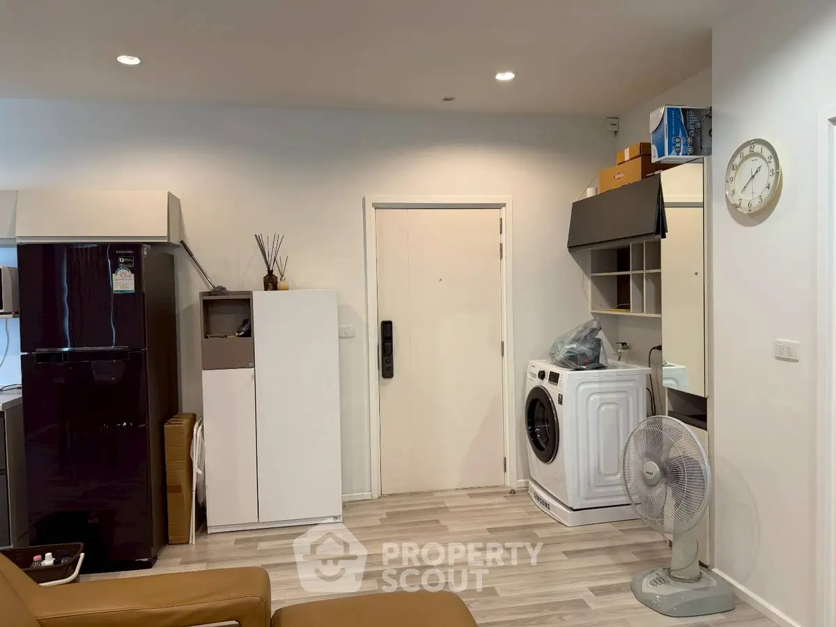 Modern apartment interior with washing machine and fridge, stylish and functional living space.