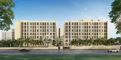 Modern apartment building with palm trees and clear blue sky, showcasing contemporary architecture.