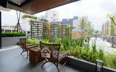Charming balcony with lush greenery and stylish seating, offering a serene urban escape.