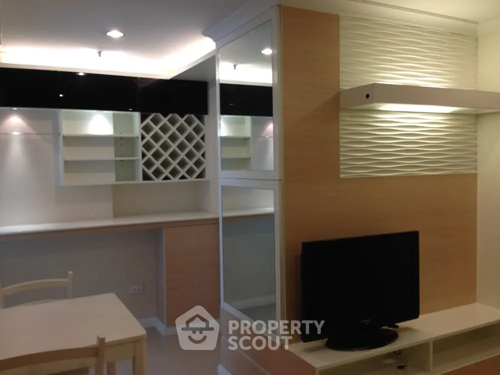 Modern living room with built-in shelves and TV unit, ideal for stylish urban living.