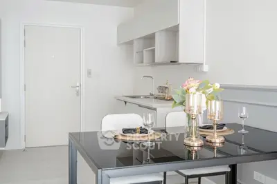 Modern kitchen with sleek dining area and elegant decor in a stylish apartment.