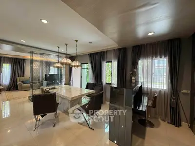 Luxurious open-plan living and dining area with elegant decor and natural light.