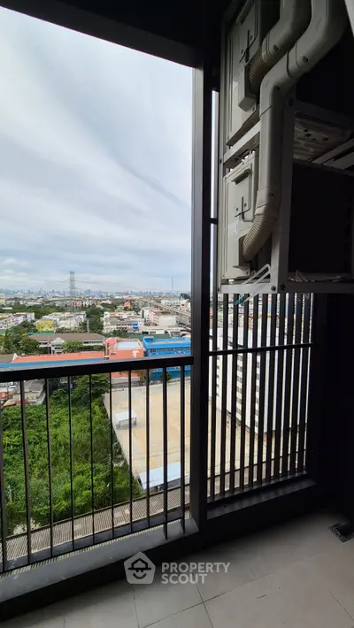 Stunning balcony view overlooking cityscape with lush greenery and urban skyline.