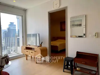 Modern living room with balcony view and stylish furniture in urban apartment.