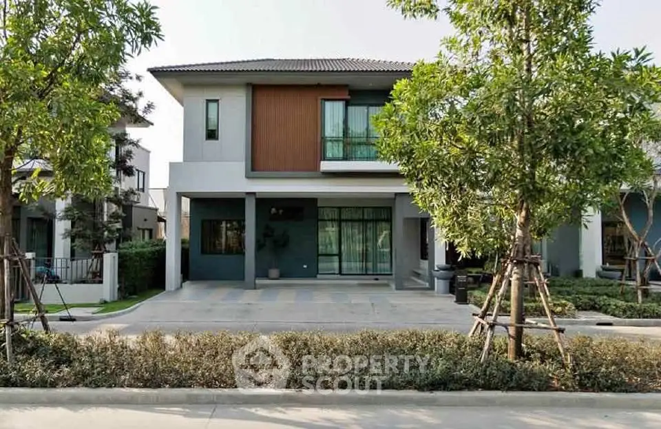 Modern two-story house with landscaped front yard and spacious driveway in a serene neighborhood.