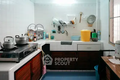 Cozy kitchen with gas stove and ample storage space, perfect for culinary enthusiasts.