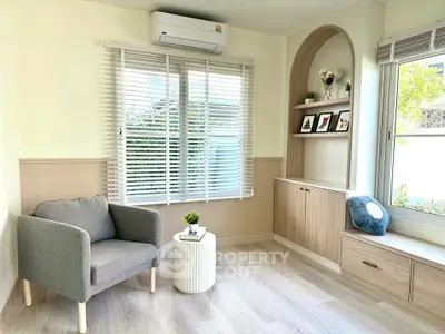 Charming living room with modern decor and large window for natural light.