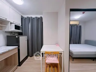 Modern studio apartment with compact kitchen and cozy bedroom