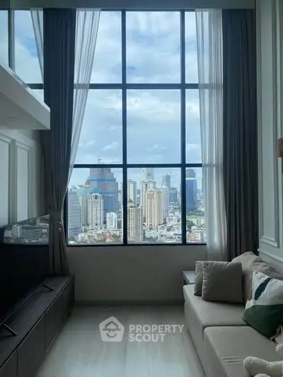 Luxurious living room with stunning city skyline view through large windows, elegant decor and cozy seating.